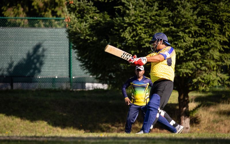 Cricketer batting during an outdoor match — Cup Match season in Bermuda